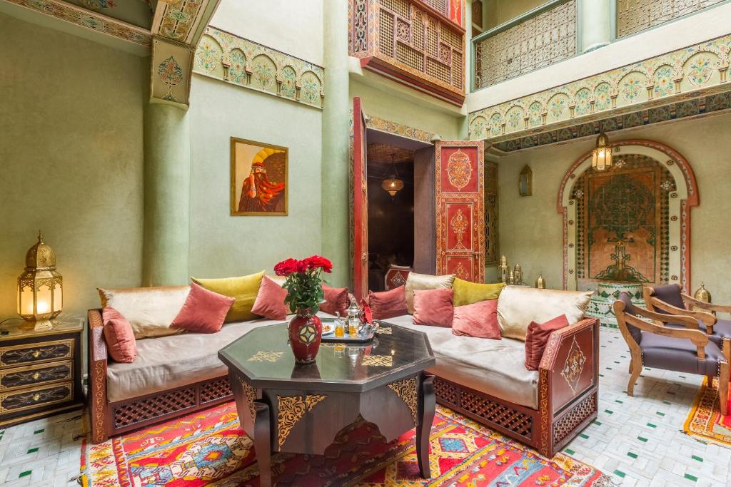 a living room with a couch and a table at Riad AZARO in Marrakesh