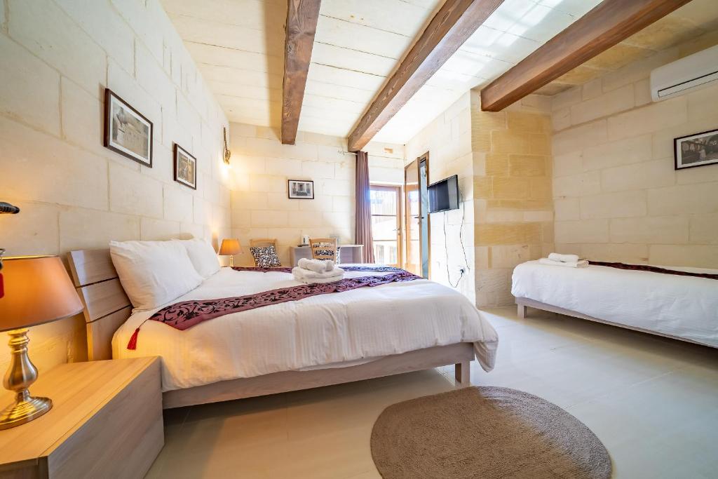 Postel nebo postele na pokoji v ubytování Ta Pinu Guesthouse