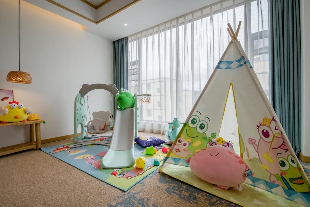 a childs room with a play area with a play tent at Yunxianju Tea Culture Theme Hotel in Kunming
