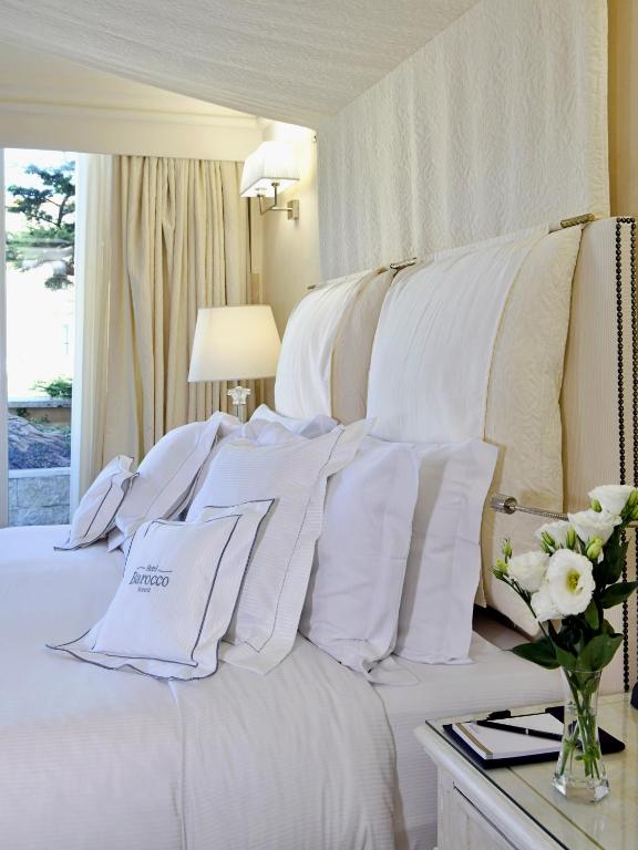 Postel nebo postele na pokoji v ubytování Hotel Barocco