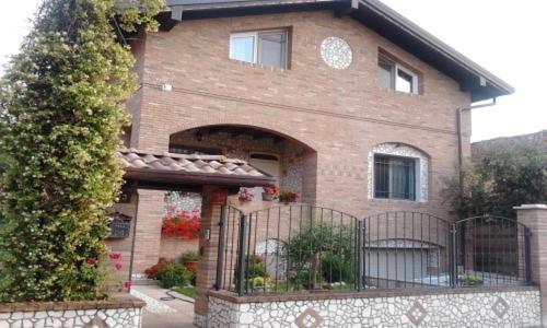 a brick house with a gate in front of it at Sosta Fiera B&B in Rho