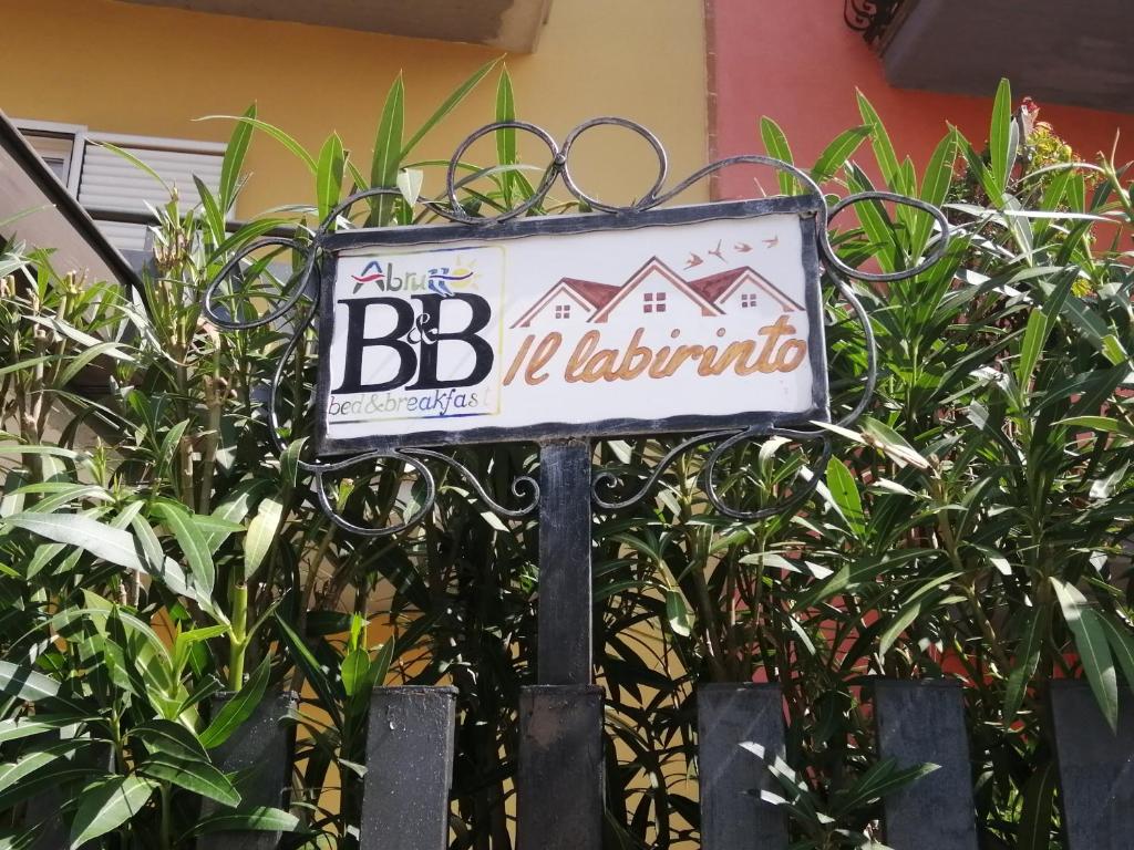 a sign in front of some plants at Il labirinto in Sulmona
