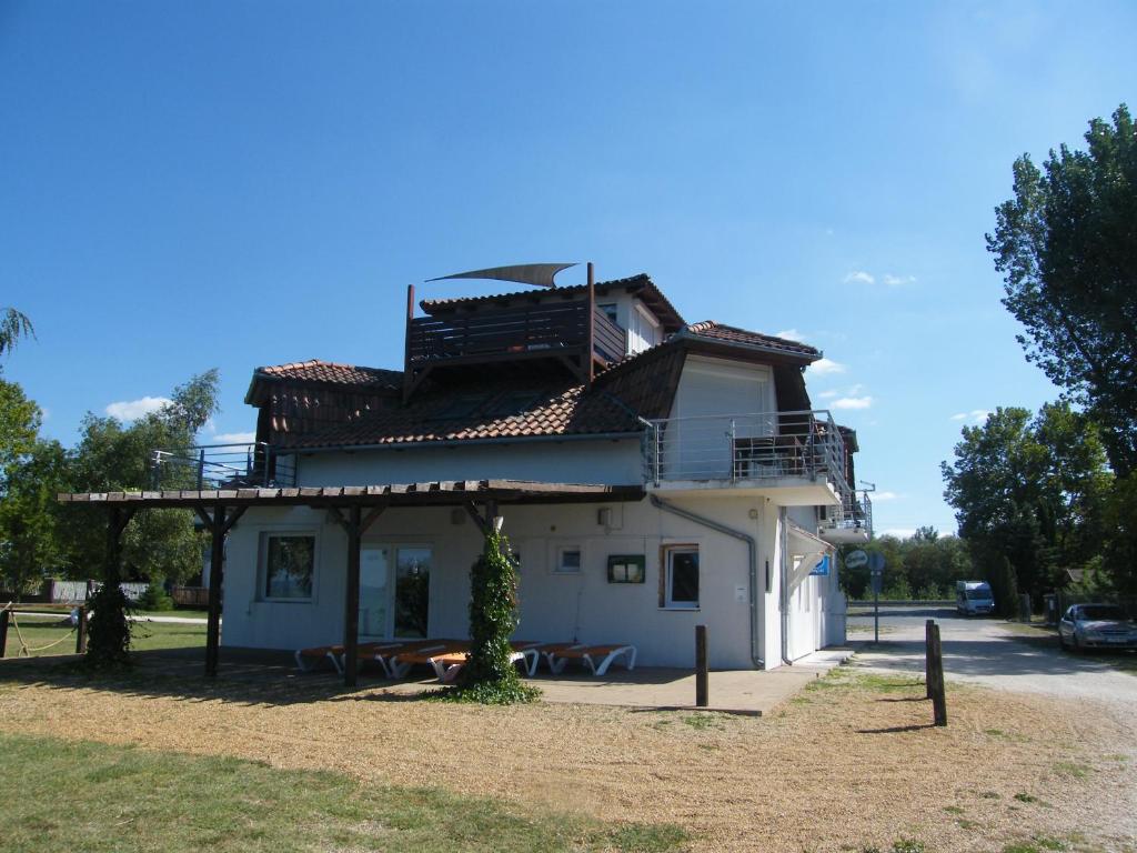 a building with a balcony on top of it at Beach Resident in Balatonszemes