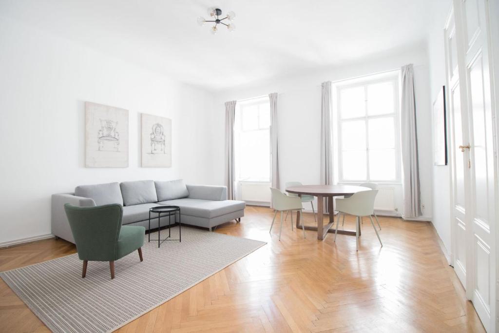 a living room with a couch and a table at HeyMi Apartments Stadtpark in Vienna