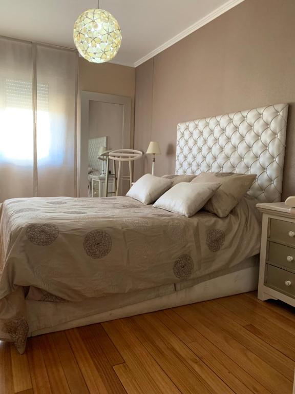 a bedroom with a large bed and a table at Oktheway Praza Galicia in Sarria