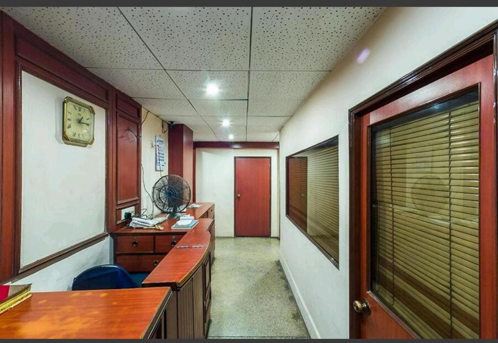an office room with a desk and a window at Continental Guest House in Kolkata