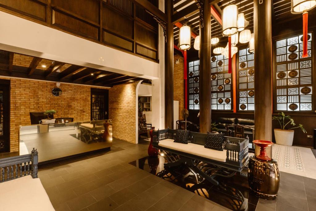 a lobby of a restaurant with tables and chairs at Saran Boutique Hotel Thapae in Chiang Mai