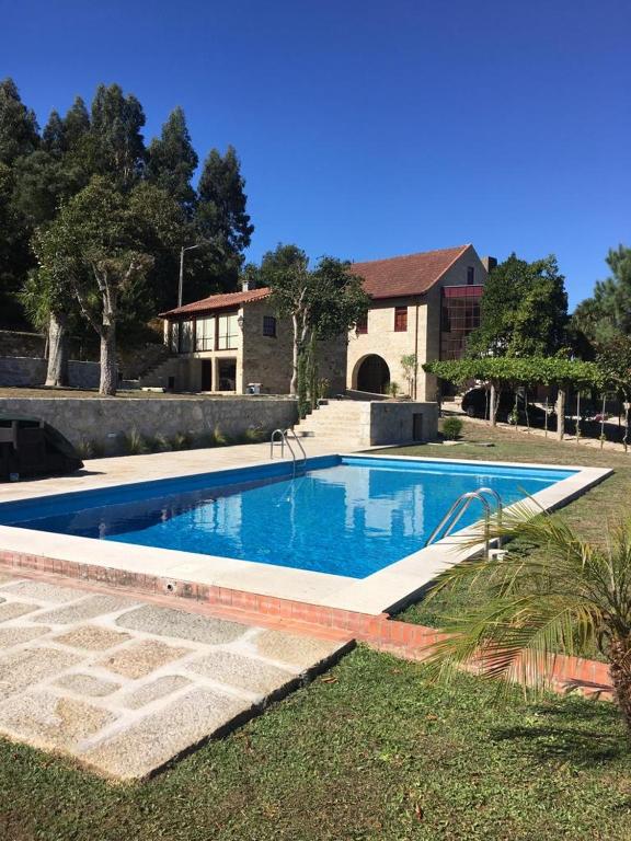 a swimming pool in front of a house at Casa Real in Barcelos