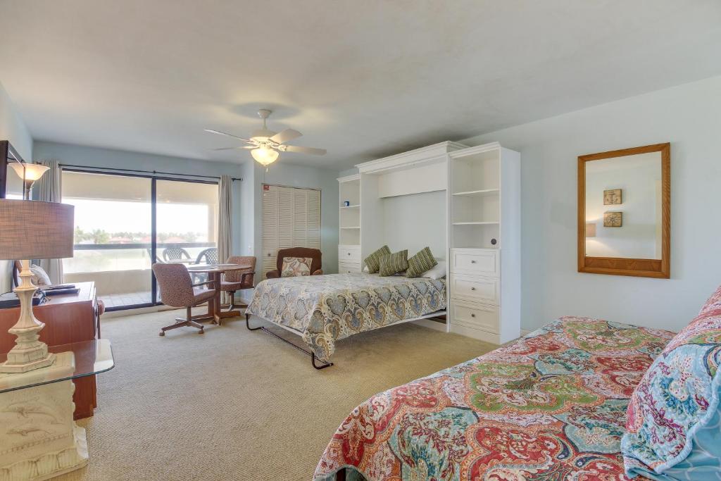 a bedroom with a bed and a desk and a table at Marina Retreat in South Padre Island