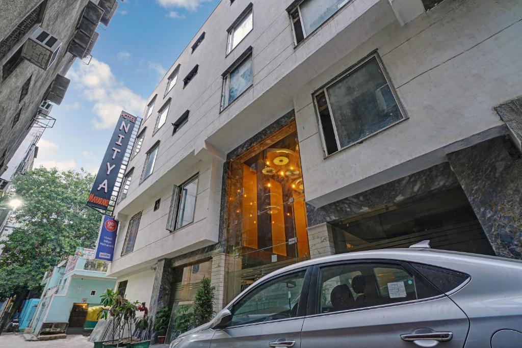 a car parked in front of a building at Staybook Hotel Nitya Maharani in New Delhi