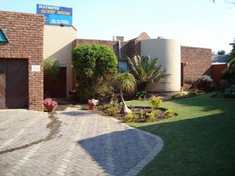 a brick building with a brick walkway in a yard at Bluewater Guesthouse in Port Elizabeth