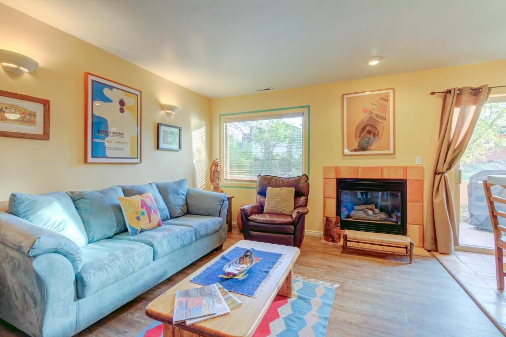 a living room with a blue couch and a fireplace at Solano Vallejo 3343 in Moab
