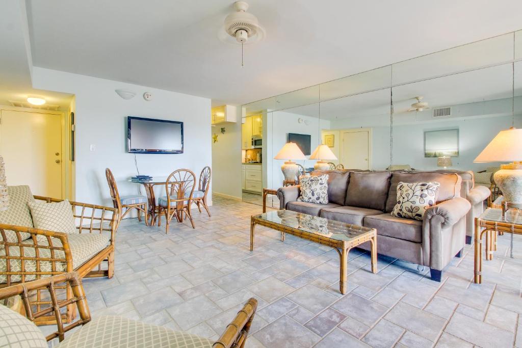 a living room with a couch and a table at Landfall Tower Unit 43 in South Padre Island