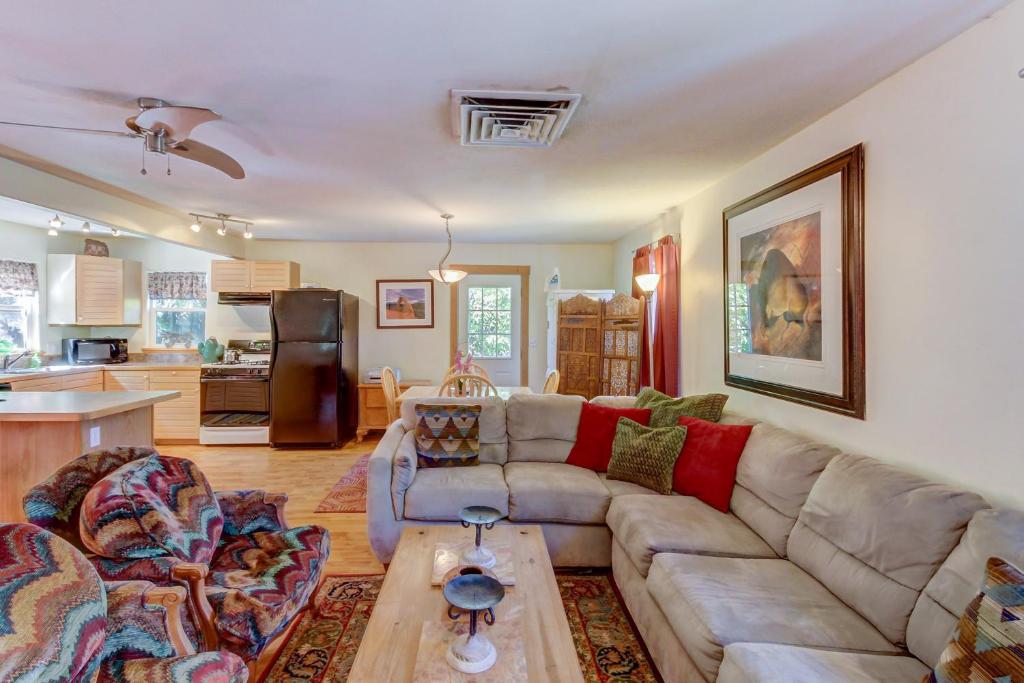 a living room with a couch and a table at Cottonwood Cottage in Moab