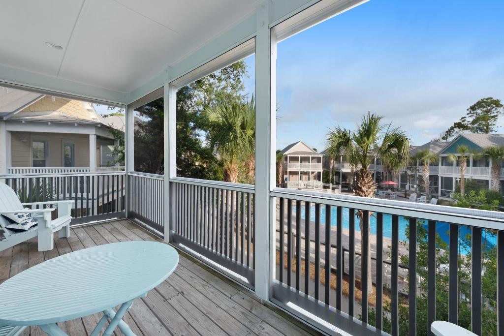 a balcony with a table and chairs and a view of the ocean at Barefoot Cottages #B32 in Highland View