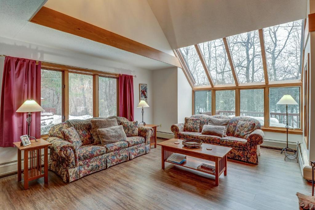 a living room with two couches and a table at Birch Landing #16 in Plymouth