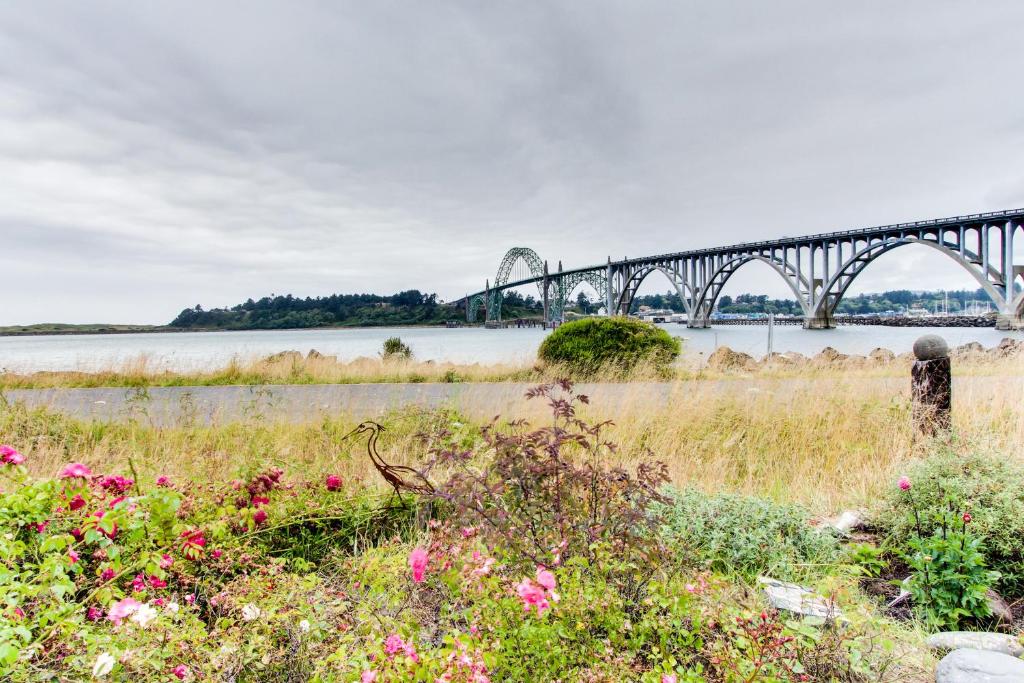 a bridge over a body of water with flowers at Casa de Margarita in Newport