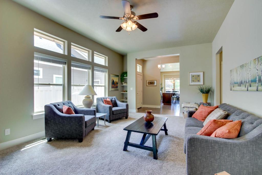 a living room with two couches and a ceiling fan at Sunglow Townhouse in Boise