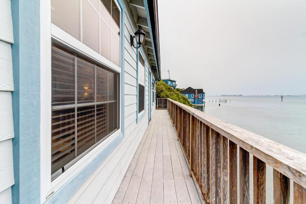 a building on a pier next to the water at Bayside Cottage in Bodega Bay