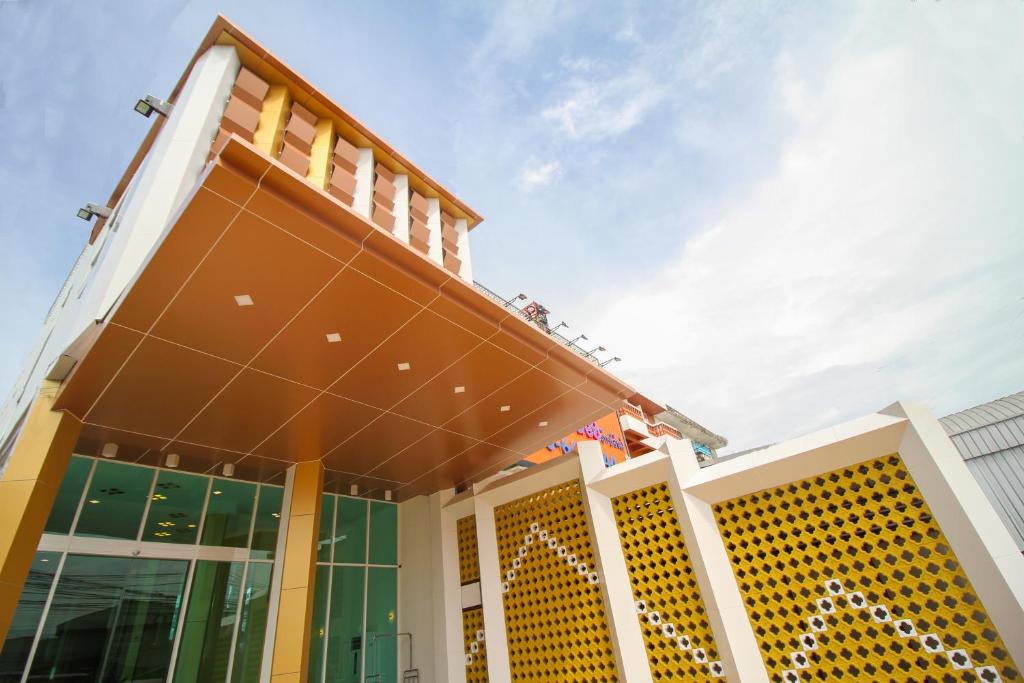 a facade of a building with the sky in the background at Convenient Grand Hotel in Lat Krabang