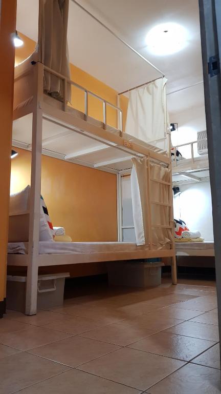a room with two bunk beds in a room at Crossroads Hostel Manila in Manila