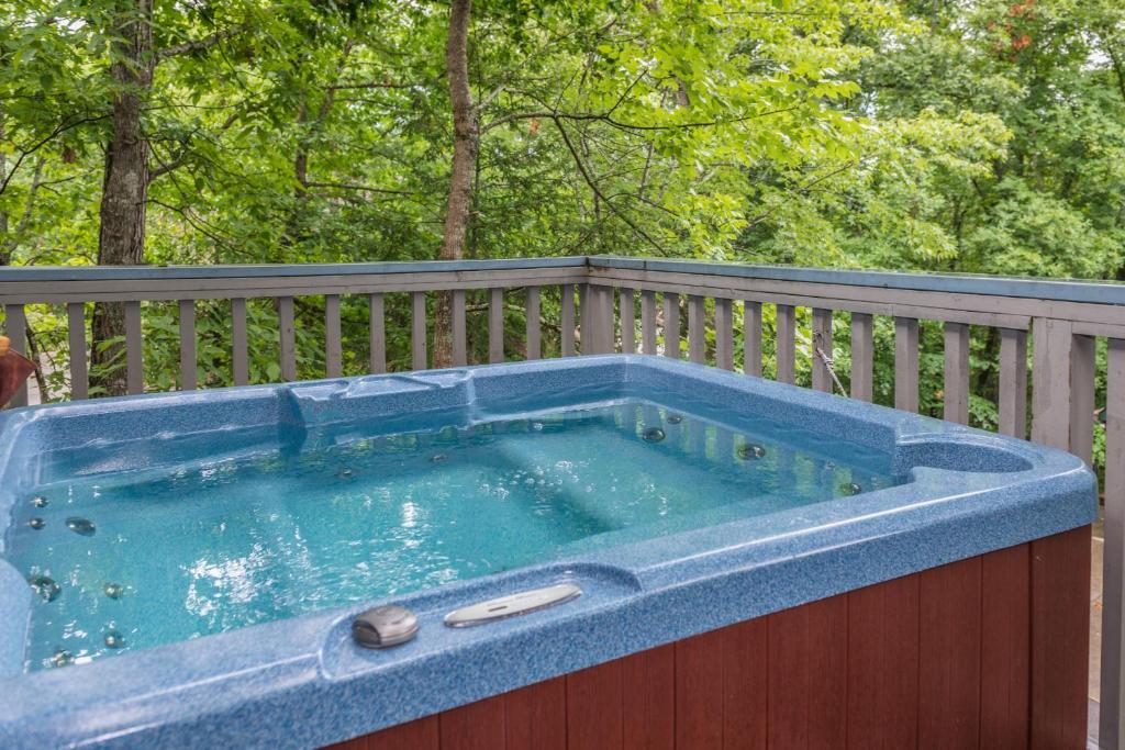 a hot tub on top of a wooden fence at Sweet Serenity in Pigeon Forge