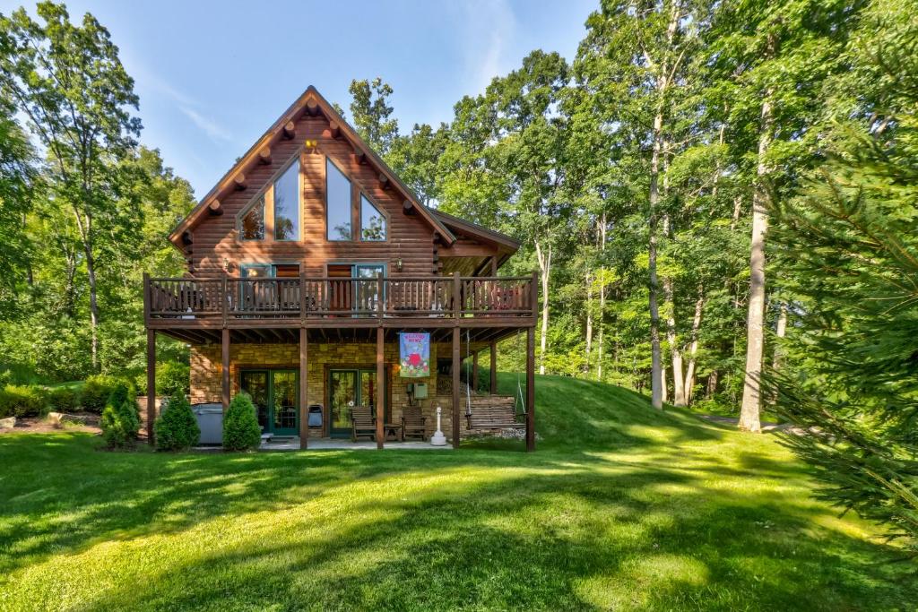 a log home with a deck in the woods at A Wispful Dream in McHenry