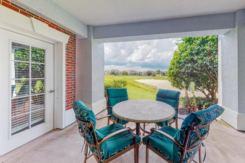 a patio with a table and chairs on a balcony at Sunset Spectacular in Kissimmee