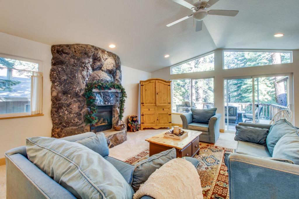 a living room with blue couches and a fireplace at Lazy Bear Retreat in Mevers