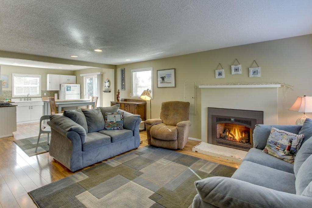 a living room with two couches and a fireplace at Gearhart Cottage North in Gearhart