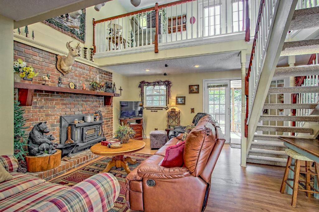 a living room with a couch and a fireplace at Bearadise in Ellijay