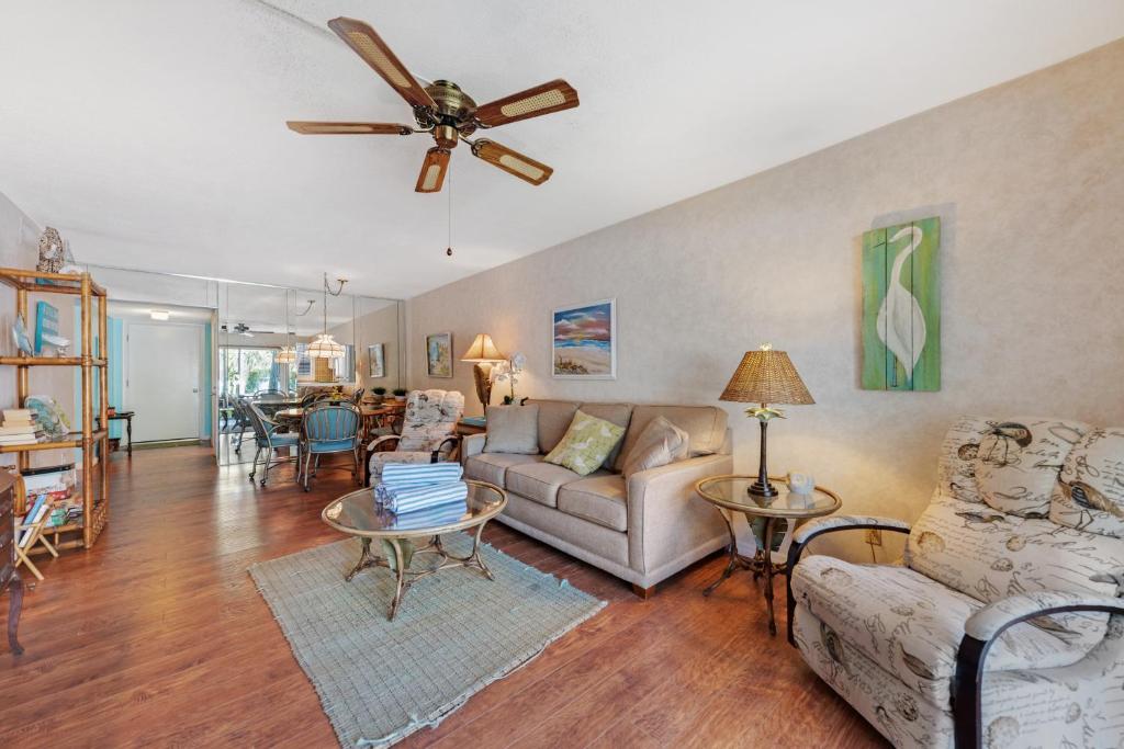 a living room with a couch and a ceiling fan at Nautilus 105 in Anna Maria