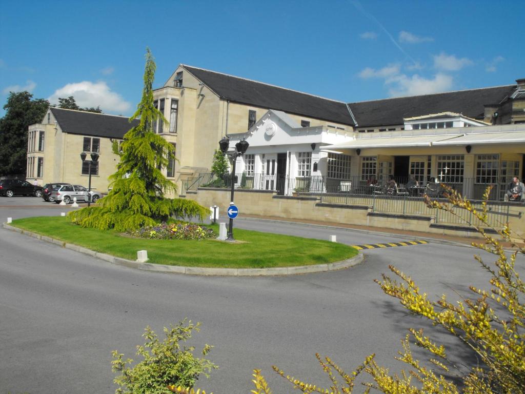 a large building with a street in front of it at Gomersal Park Hotel & Dream Spa in Cleckheaton