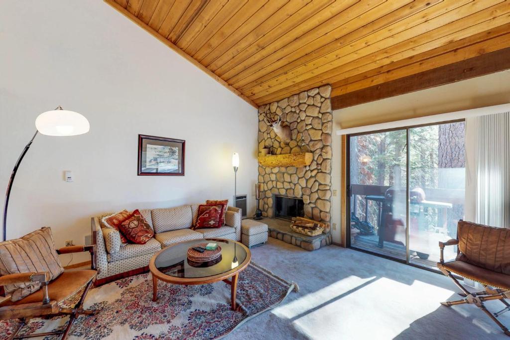 a living room with a couch and a fireplace at Huntington Lake Condo 92 in Lakeshore