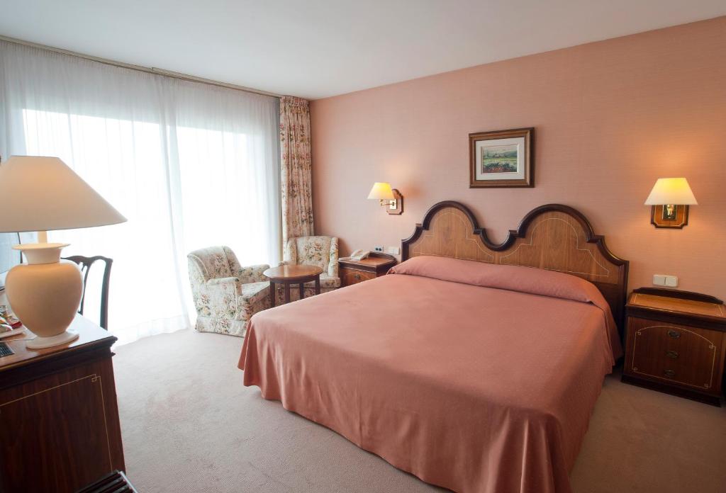 Postel nebo postele na pokoji v ubytování Hotel Riu Fluviá