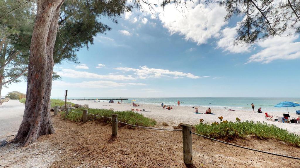 um grupo de pessoas numa praia perto do oceano em Safari Suite em Bradenton Beach