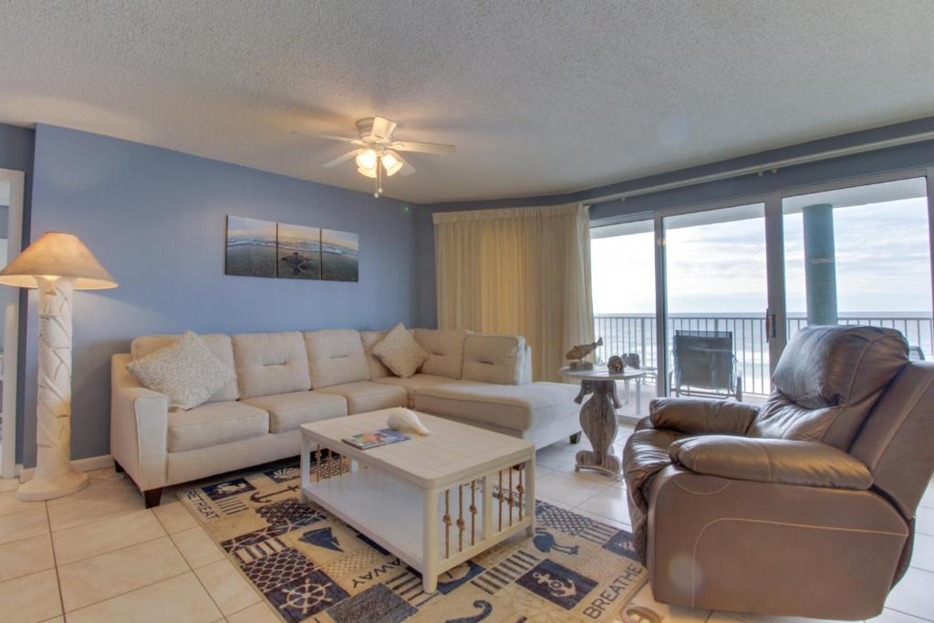a living room with a couch and a table at Long Beach Resort #T2-304 in Panama City Beach