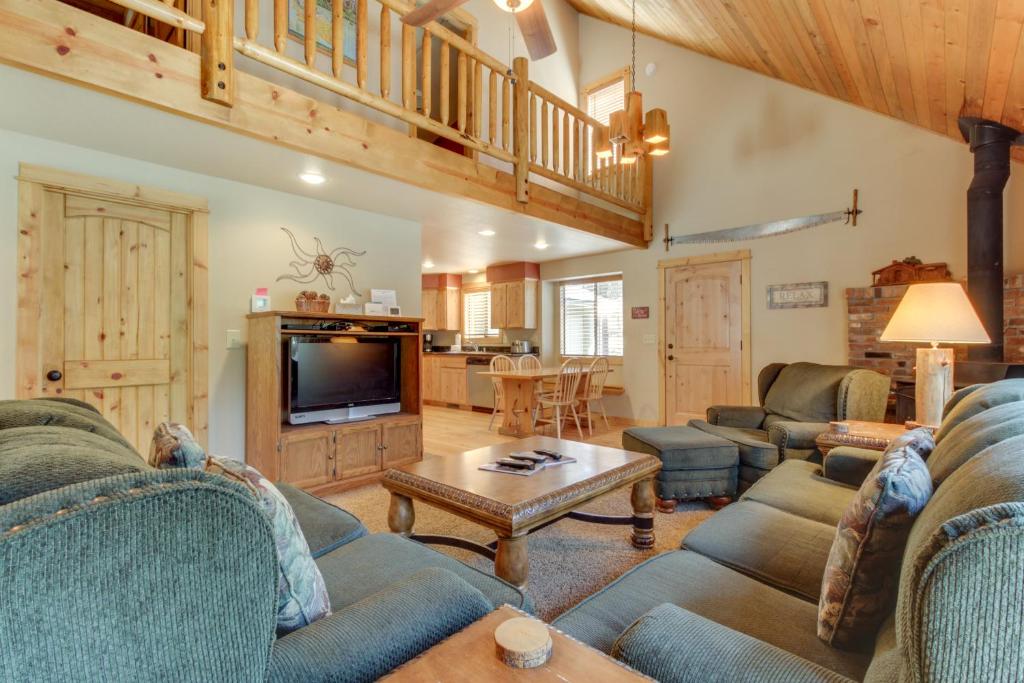 a living room with two couches and a tv at 13 Deer Lane in Sunriver