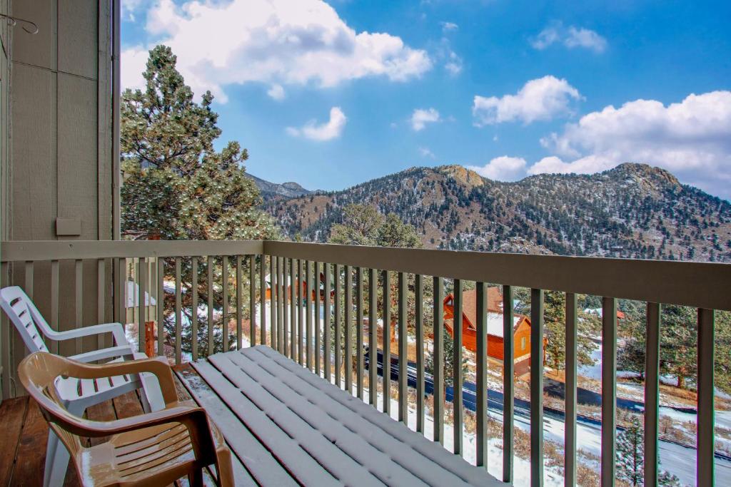 a balcony with a bench and a view of mountains at Camelot on Deer Mountain - Permit #3109 in Estes Park