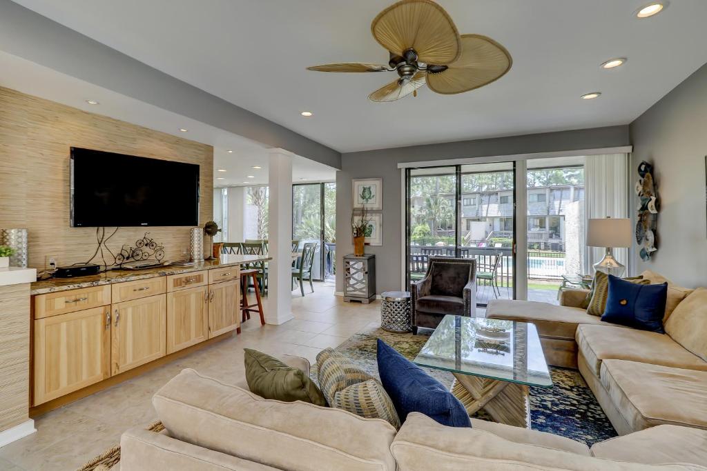 a living room with a couch and a flat screen tv at Harbour Town Club Villas 1253 in Hilton Head Island