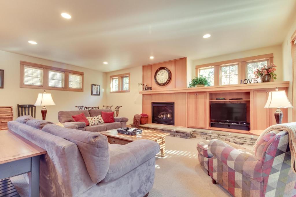a living room with two couches and a fireplace at 29 Fremont Crossing in Sunriver