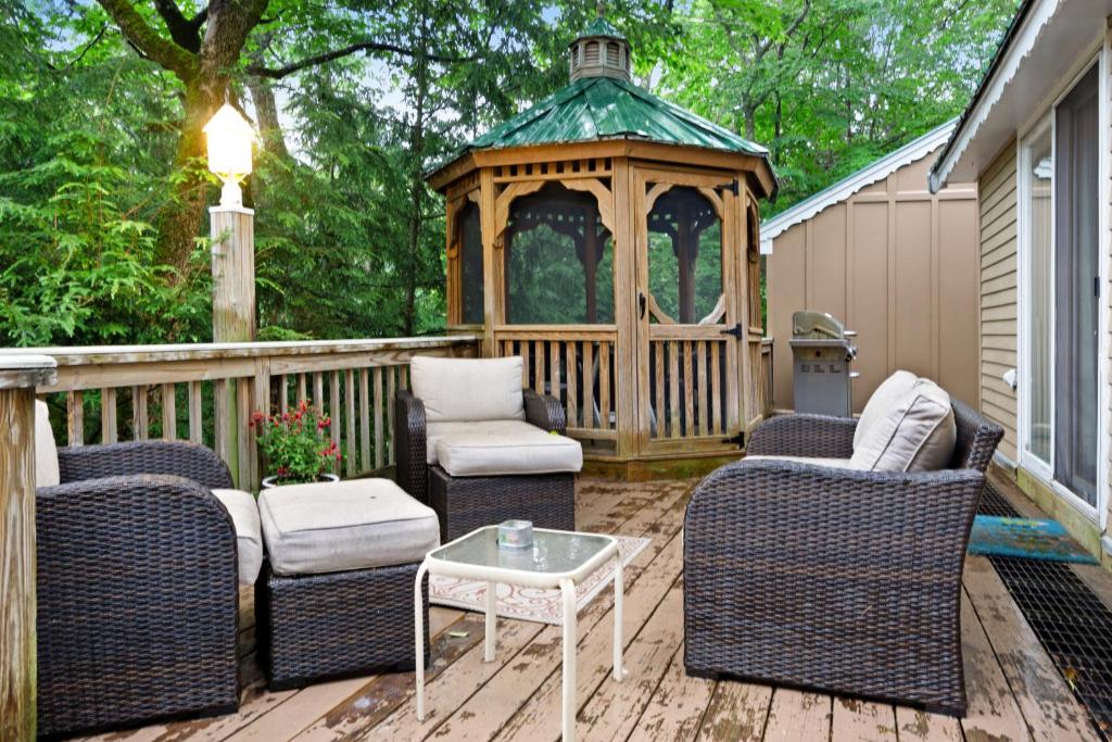 a gazebo on a deck with chairs and a table at 79 Covered Bridge Lane in Bartlett