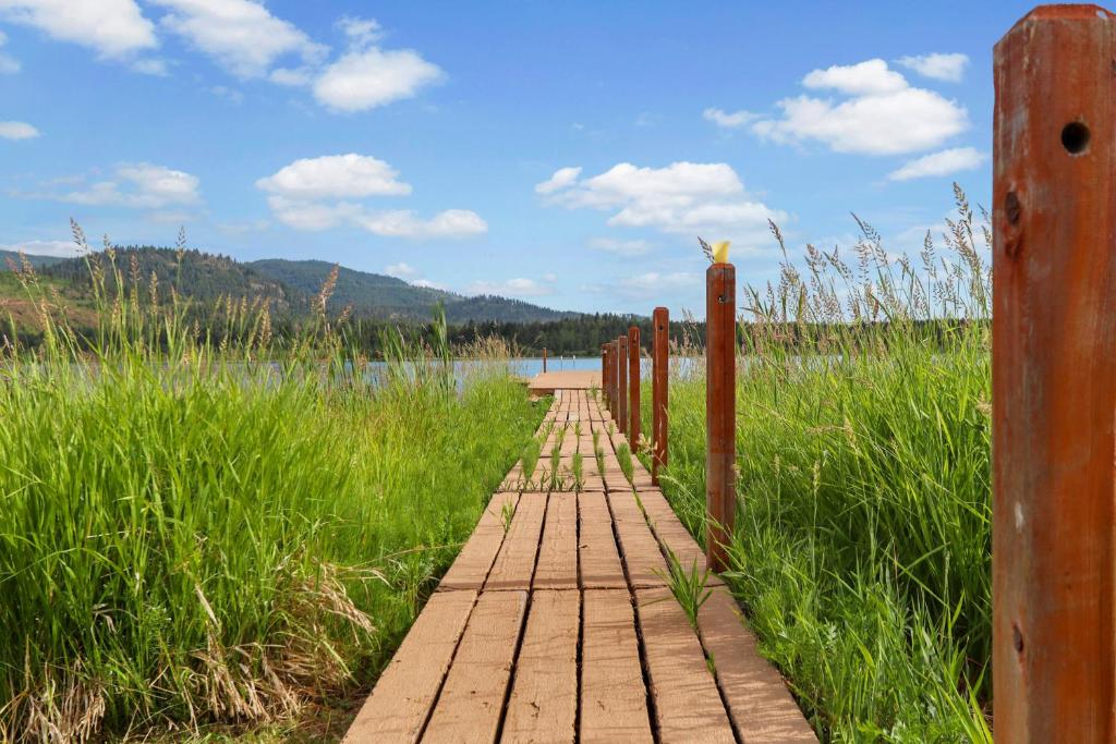 a wooden pathway leading to a body of water at Conrad Vista Waterfront Home in Laclede