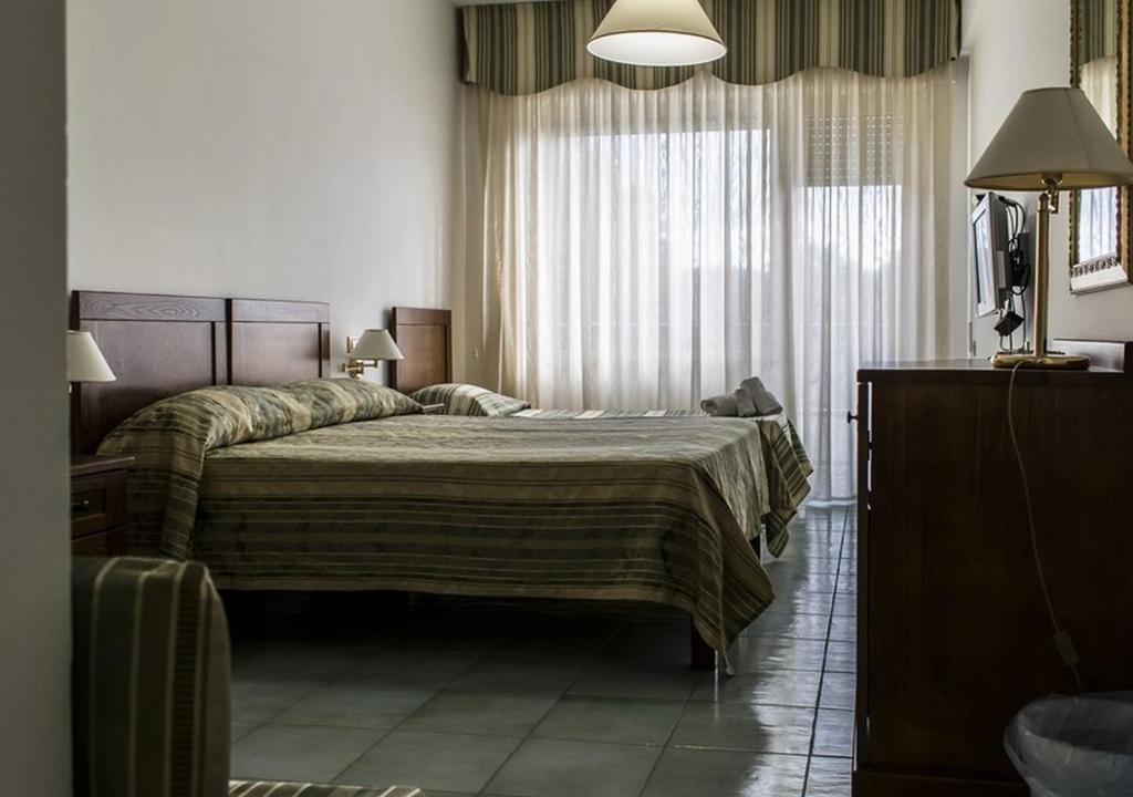 Postel nebo postele na pokoji v ubytování Hotel Baia