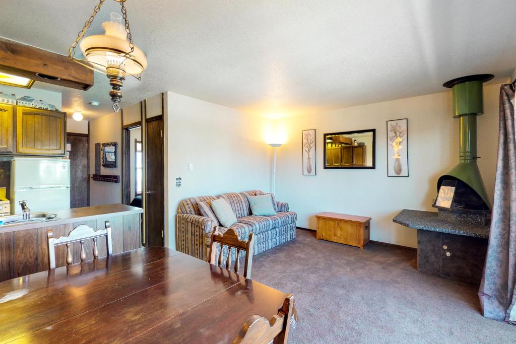 a kitchen and living room with a table and a couch at Red Cricket 22 in Sandpoint