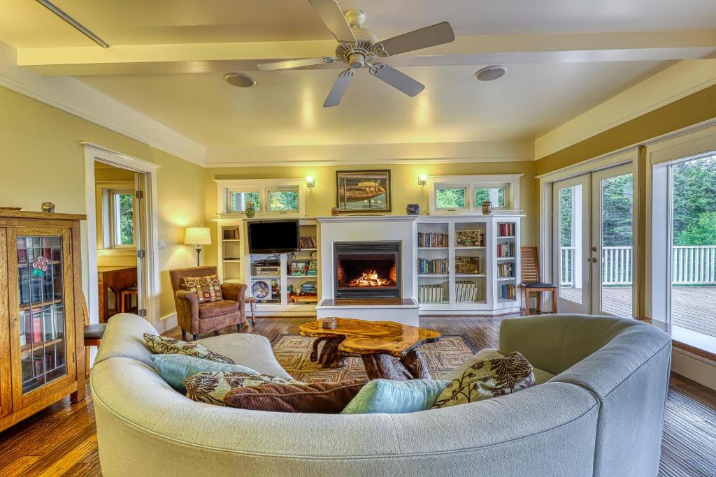 a living room with a couch and a fireplace at 6 Bed 4 Bath Vacation home in Eastsound in Eastsound