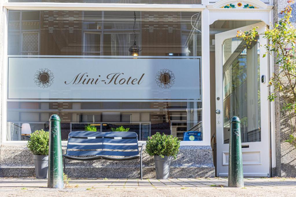 a store front with two chairs in front of a store at Sleep&Stay Floris IV in The Hague