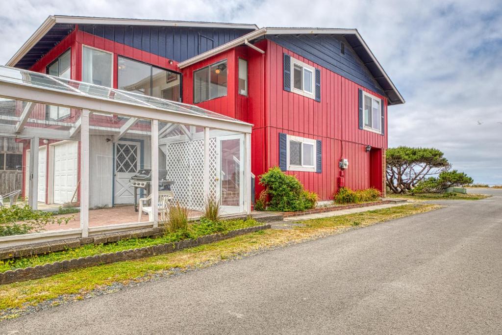 a red house with a black roof at Tidal Links - 4 Bed 3 Bath Vacation home in Bandon Dunes in Bandon