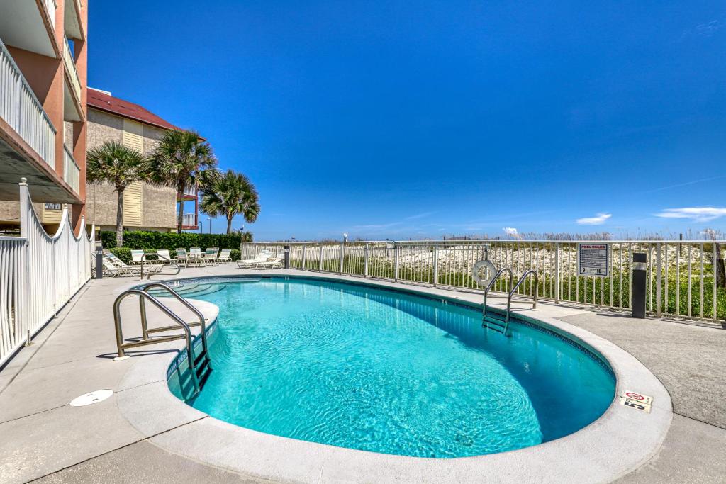 a swimming pool in the middle of a yard at Tropic Isle in Gulf Shores