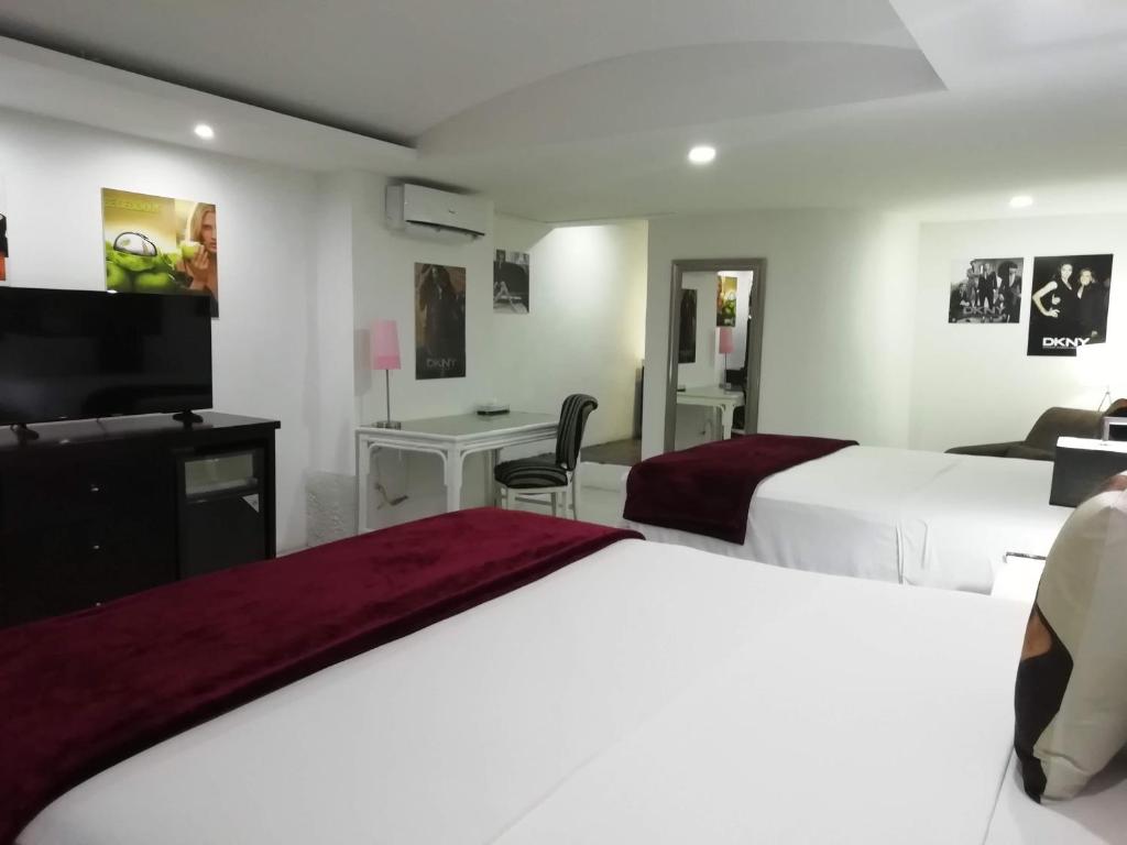 Postel nebo postele na pokoji v ubytování MayaFair Design Hotel